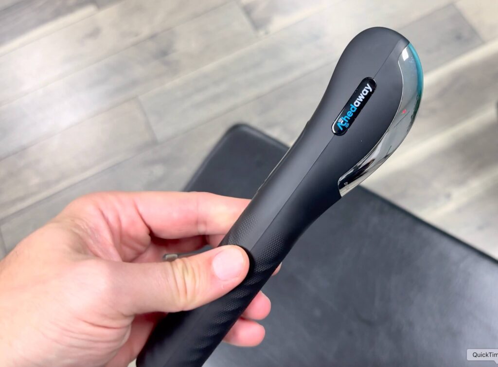 a hand holding an achedaway scraper for a product review